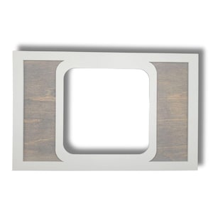 May include: A white picture frame with a woodgrain insert on each side. The frame has a slightly rounded edge.