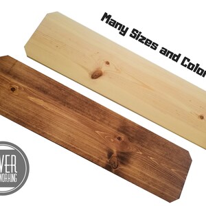 May include: Two wooden boards, one stained brown and one natural wood, with rounded edges. The text "Many Sizes and Colors!" is written above the boards. The logo "SLIVER WOODWORKING" is in a circle below the boards.