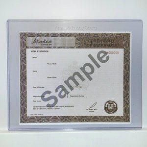 May include: A white certificate of marriage from Alberta, Canada. The certificate has a brown border and the text "Certificate of Marriage" and "LM000000" printed in brown. The text "Vital Statistics" is printed in black at the top of the certificate.