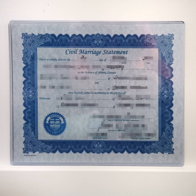 May include: A blue and white framed document with the title "Civil Marriage Statement". The document is printed on a light blue background with a decorative border. The document includes the date, names of the couple, and the name of the officiant.