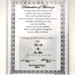 May include: A white framed certificate with a black border and a decorative design. The certificate reads "Declaration of Marriage" and includes a vow promising love, respect, and faithfulness. The certificate also includes the text "We DREAMS Riviera Cancun Resort & Spa" and the words "Bride", "Groom", and "Officiant".
