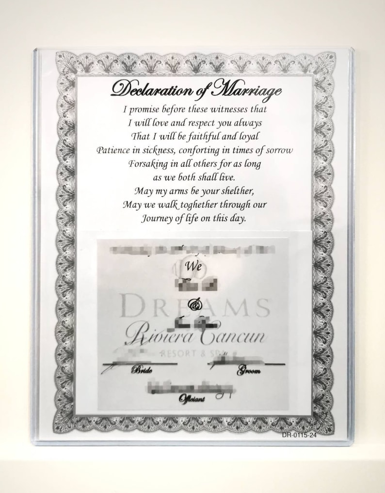 May include: A white framed certificate with a black border and a decorative design. The certificate reads "Declaration of Marriage" and includes a vow promising love, respect, and faithfulness. The certificate also includes the text "We DREAMS Riviera Cancun Resort & Spa" and the words "Bride", "Groom", and "Officiant".
