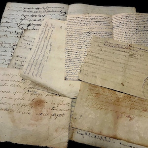 May include: A selection of antique handwritten documents, featuring faded ink on aged, yellowed paper. The papers are arranged in a layered composition, with visible cursive script. Some pages are open, revealing more text.