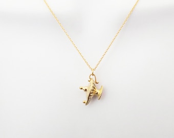 May include: A gold chain necklace with a pendant shaped like a small oil lamp.