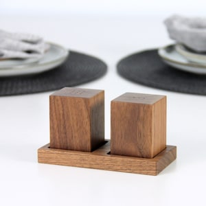 Walnut wood salt and pepper shakers with a stylish tray, perfect for seasoning your favorite dishes