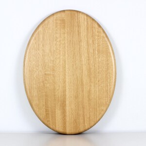 Handcrafted oval serving tray made from premium oak wood, featuring a smooth finish and natural wood grain. Perfect as a large ottoman tray, charcuterie board, or tea serving tray for home decor and entertaining