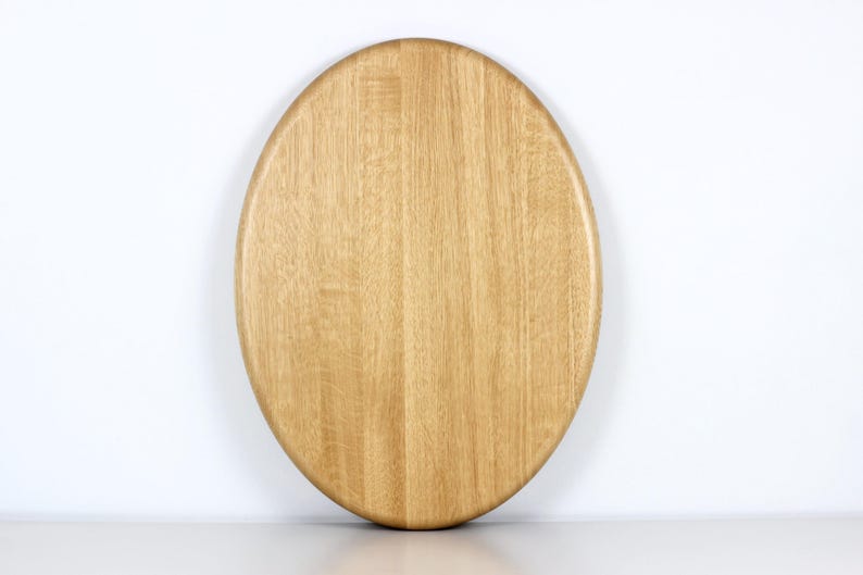 Handcrafted oval serving tray made from premium oak wood, featuring a smooth finish and natural wood grain. Perfect as a large ottoman tray, charcuterie board, or tea serving tray for home decor and entertaining