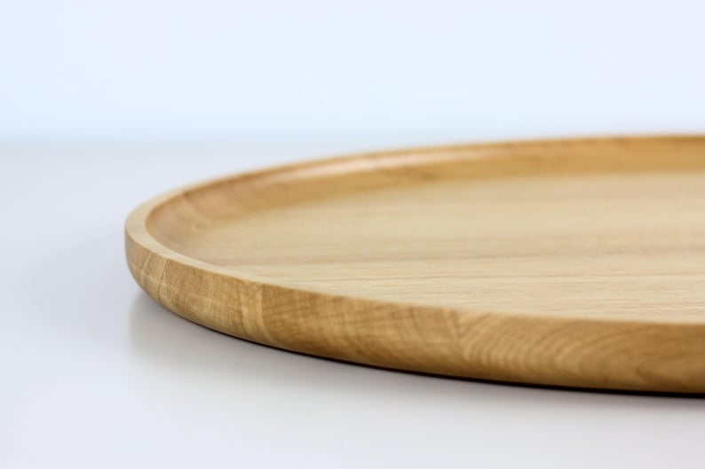 Handcrafted oval serving tray made from premium oak wood, featuring a smooth finish and natural wood grain. Perfect as a large ottoman tray, charcuterie board, or tea serving tray for home decor and entertaining