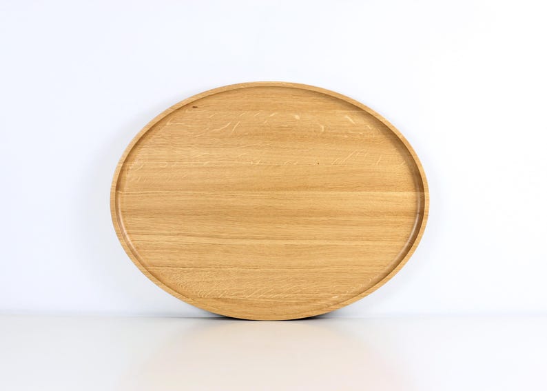 Handcrafted oval serving tray made from premium oak wood, featuring a smooth finish and natural wood grain. Perfect as a large ottoman tray, charcuterie board, or tea serving tray for home decor and entertaining