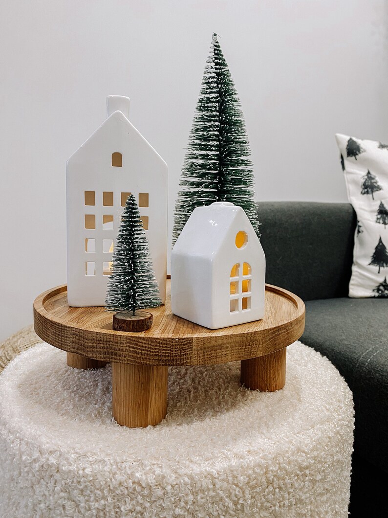 A wooden serving tray and cake stand made from oak wood. This farmhouse-inspired cake stand adds a rustic touch to your wedding cake display