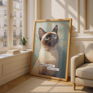 May include: A framed wall art print featuring a Siamese cat with blue eyes against a light blue background with gold leaf patterns. The text "Because I said so... that's why!" is printed in white boxes over the cat's chest area.
