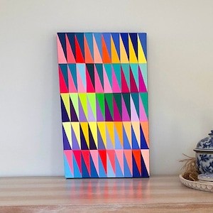 Neon Triangles no. 2, acrylic gouache painting on wood panel, fluoresces under black light