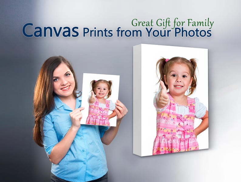 May include: A woman is holding a canvas print of a young girl giving a thumbs up. The print is on a white background. The text "Great Gift for Family Canvas Prints from Your Photos" is at the top of the image.