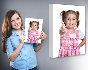 May include: A woman holds a photo of a young girl with a pink and yellow dress giving a thumbs up. The girl in the photo has her hair pulled back in pigtails.