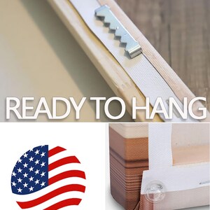 May include: A close-up of a wooden frame with a metal sawtooth hanger attached to the back. The frame is labeled "Ready to Hang" and has a "Made in USA" sticker on the front. The frame also has clear plastic corner bumpers.