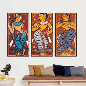 May include: Three framed paintings depicting women in traditional Indian clothing. The women are painted in a colorful, stylized manner with bold lines and bright colors. The paintings are set against a red background.