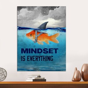 May include: A motivational poster with a goldfish wearing a shark fin and the text "Mindset is Everything". The goldfish is swimming in blue water with a cloudy sky in the background.
