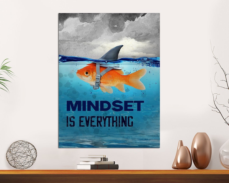 May include: A motivational poster with a goldfish wearing a shark fin and the text "Mindset is Everything". The goldfish is swimming in blue water with a cloudy sky in the background.