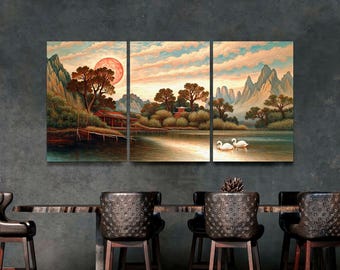 May include: A triptych canvas print depicting a serene Asian landscape. The artwork features a lake with two swans, mountains, trees, and a red sun setting in the sky. The color palette includes shades of orange, blue, and green.
