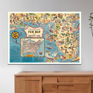 May include: A vintage travel poster for Greyhound bus lines. The poster features a colorful map of the United States with a focus on the "Sunshine Zone" of Florida. The map is filled with illustrations of popular attractions and activities, including beaches, amusement parks, and historical landmarks. The poster is a fun and nostalgic reminder of the joys of travel.