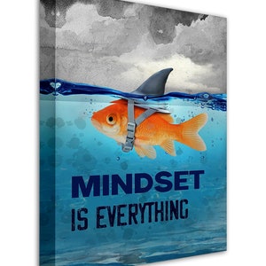 May include: A motivational canvas print with a goldfish wearing a shark fin and a life vest, swimming in blue water with the text "MINDSET IS EVERYTHING".