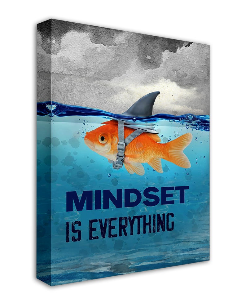 May include: A motivational canvas print with a goldfish wearing a shark fin and a life vest, swimming in blue water with the text "MINDSET IS EVERYTHING".