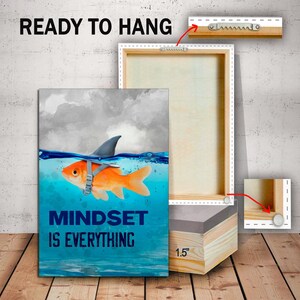 May include: A canvas print with a motivational quote, "Mindset is Everything", featuring a goldfish wearing a shark fin. The print is ready to hang with a 1.5 inch wooden frame.