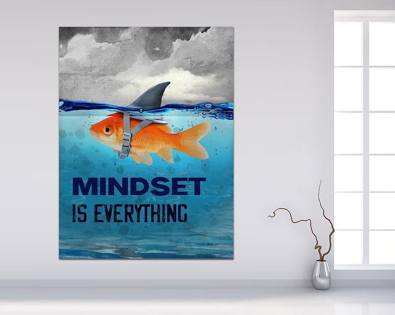 May include: A motivational poster with a goldfish wearing a shark fin and the text "Mindset is Everything" in blue letters on a blue and white watercolor background.
