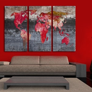 May include: A three-piece canvas wall art set featuring a red world map on a gray and white textured background. The artwork is displayed above a gray couch in a red room.