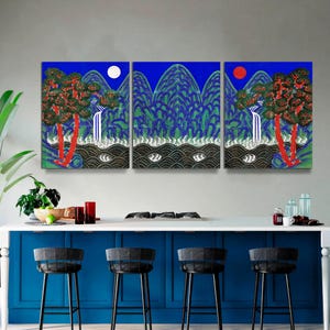 May include: Triptych wall art featuring a stylized landscape with mountains, trees, and waterfalls. The artwork has a blue background with a white moon and a red sun. The trees have red trunks and green and red foliage.