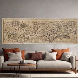 May include: A large, rectangular map print with a detailed, sepia-toned illustration of a fantasy landscape. The map features castles, rivers, and various symbols, framed by a decorative border. The print is displayed above a modern sofa with orange and neutral-colored pillows.