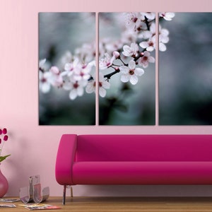 May include: A tri-panel canvas print featuring a close-up of delicate white blossoms on a branch against a blurred green background.