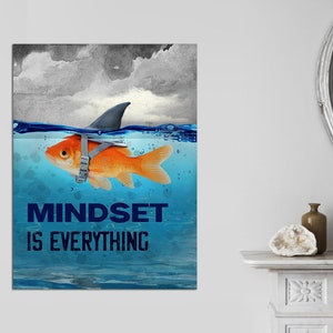 May include: A motivational poster with a goldfish wearing a shark fin and the text "Mindset is Everything". The goldfish is swimming in blue water with a cloudy sky in the background.