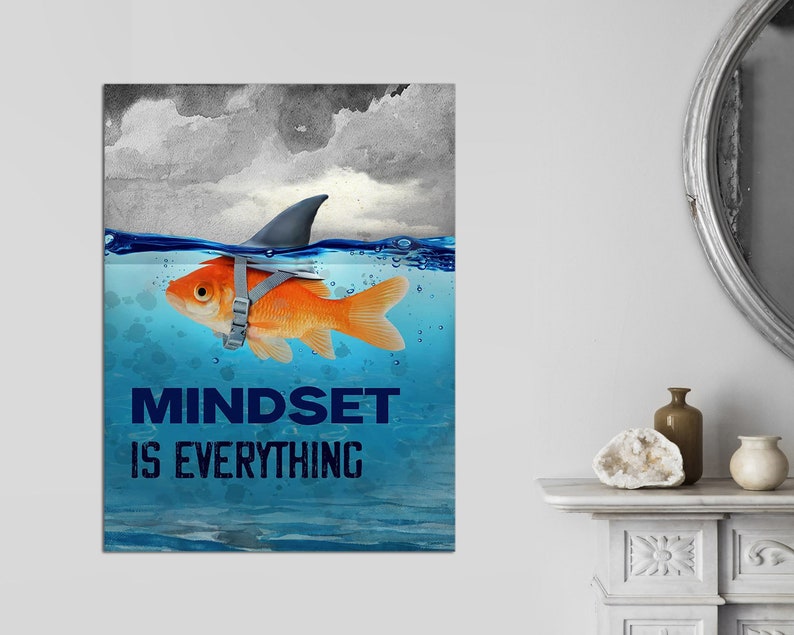 May include: A motivational poster with a goldfish wearing a shark fin and the text "Mindset is Everything". The goldfish is swimming in blue water with a cloudy sky in the background.