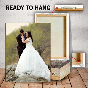 May include: A wedding photo canvas print of a couple in a field. The canvas is ready to hang with a 1.5 inch wooden frame and sawtooth hangers.
