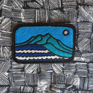 May include: A handmade wooden sign, painted white with a distressed finish, bearing the word "Welcome" in a handwritten font. A small, green leafy branch adorns the top. Suitable for indoor or outdoor display.