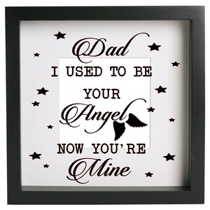May include: Black framed picture with a white background and black text that reads "Dad I used to be your Angel now you're mine". The text is surrounded by small black stars.