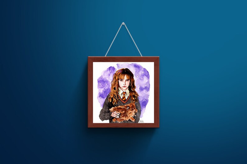 May include: A square wooden frame containing a watercolor illustration of a person with long wavy brown hair, wearing a grey sweater, white collared shirt, and striped tie, holding a small brown creature against a purple starry background.