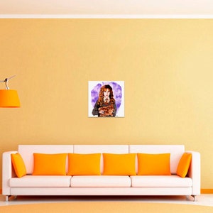 May include: A square wall art print featuring a watercolor illustration of a young person with long wavy brown hair, wearing a grey sweater, white collared shirt, and a striped tie, holding a brown cat against a purple abstract background.