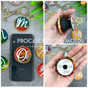 May include: A set of colorful resin phone grips with gold accents and glitter. The grips are shaped like circles and feature different letters. The grips are shown on a phone case and in a hand. The text "PROCASE.DESIGN_MOLDS HANDMADE SILICONE MOLDS" is visible in the image.