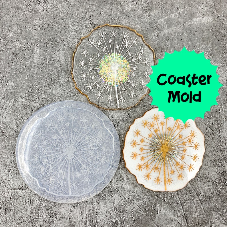 May include: Three resin coaster molds in the shape of a dandelion. The molds are white and have a delicate, detailed design. The text "Coaster Mold" is printed on a green circle.