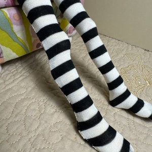 May include: Black and white striped stockings with a white background and black stripes.