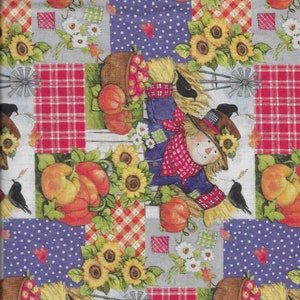 May include: A patchwork fabric featuring a repeating pattern of scarecrows, pumpkins, sunflowers, and birds. The fabric is in shades of red, blue, yellow, green, and brown.