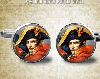 May include: A pair of silver-plated cuff links with a 3/4 inch diameter. Each cuff link features a round, colorful image of Napoleon Bonaparte in a military uniform. The image is set in a silver-plated bezel.