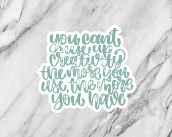May include: A teal blue sticker with the text "You can't use up creativity. The more you use, the more you have."