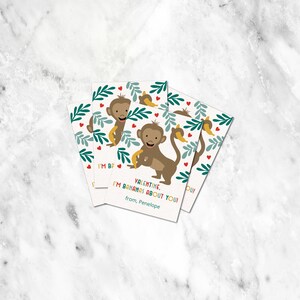 May include: A set of four Valentine's Day cards featuring a cartoon monkey holding a banana. The cards have a green, white, and red background with hearts and leaves. The text on the cards reads "Valentine, I'm bananas about you!" from Penelope.