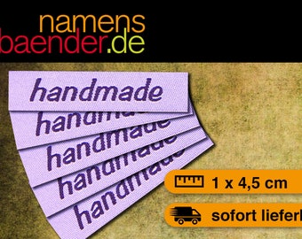May include: Five purple fabric labels with the word "handmade" embroidered in dark purple thread. The labels are 1 by 4.5 centimeters.