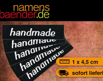 May include: Five black fabric labels with white text that reads "handmade". The labels are 1 by 4.5 centimeters.