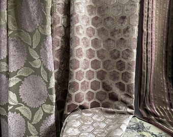 Può includere: Tre campioni di tessuto, uno con un motivo floreale in tonalità di verde e viola, uno con un motivo geometrico di esagoni in tonalità di viola e beige e uno con strisce verticali in tonalità di viola, beige e bianco.