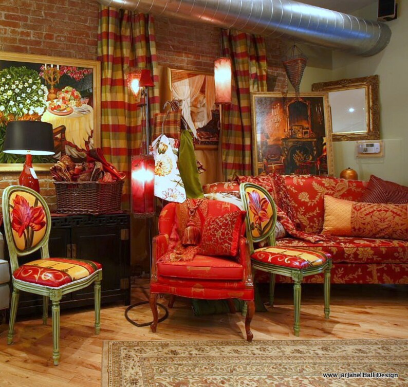 May include: A red and gold patterned sofa with pillows and two red chairs with floral designs. The chairs and sofa are in a room with red and gold patterned curtains and a rug.